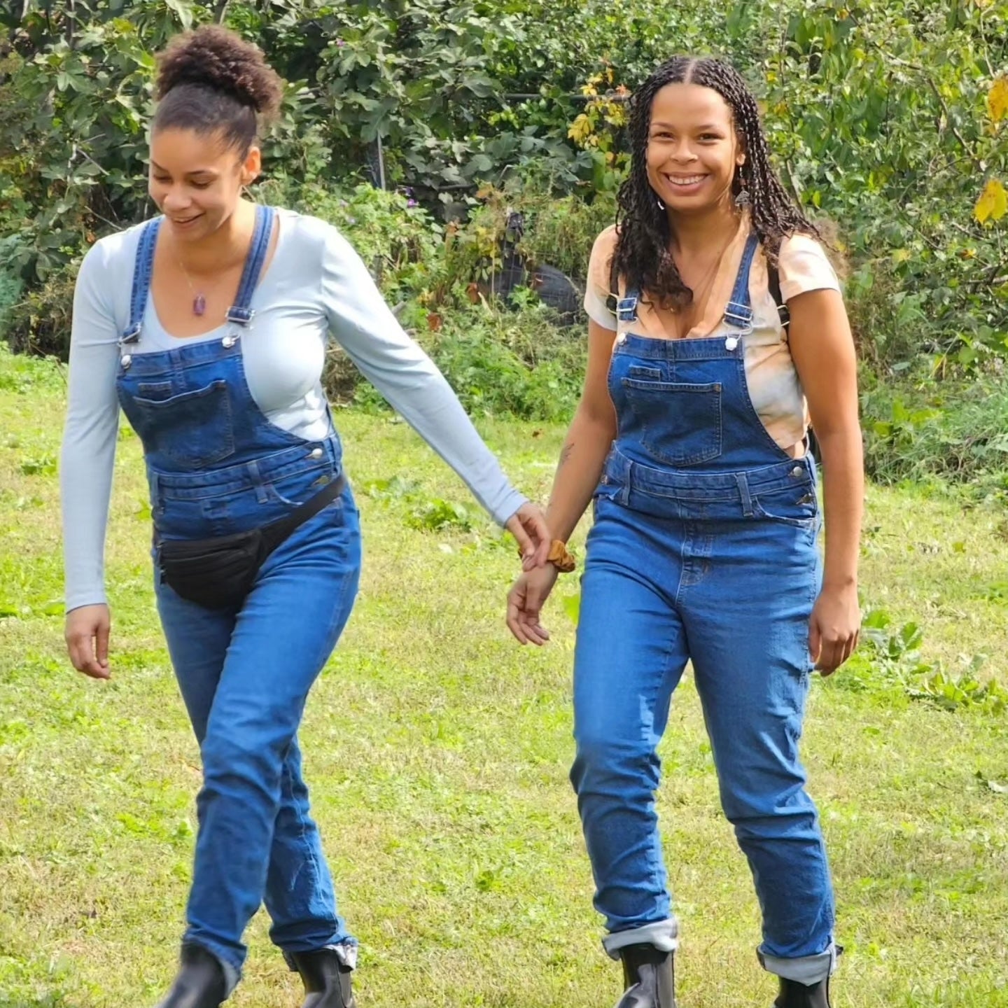 Dennise Mofidi and Jasmine Barber, Pharm to Body co-founders and the Spore Sistaz, holding hands in a Portland field